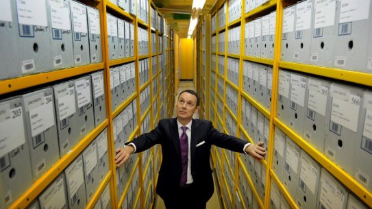 Director-general of the National Archives, David Fricker stands among the archives boxes at its Canberra repository in 2012.