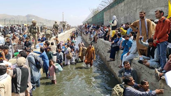 ‘Children vanished’: The scramble to access Hamid Karzai International Airport in Kabul after the Taliban takeover.