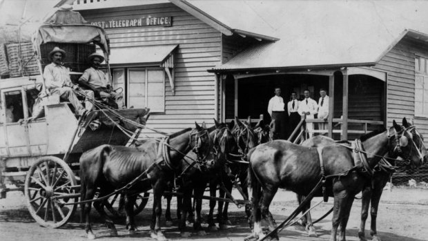 The photograph was originally titled 'Cobb & Co. coach in front of a unknown post office, ca. 1920' until a viewer helped determine the unnamed post office could be the Cloncurry Post and Telegraph Office.