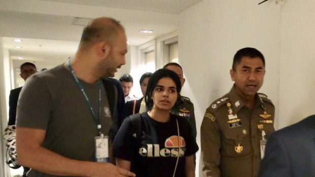 Chief of Immigration Police, Major General Surachate Hakparn (right) walks with Rahaf Mohammed al-Qunun as she leaves Suvarnabhumi Airport in Bangkok on Monday.