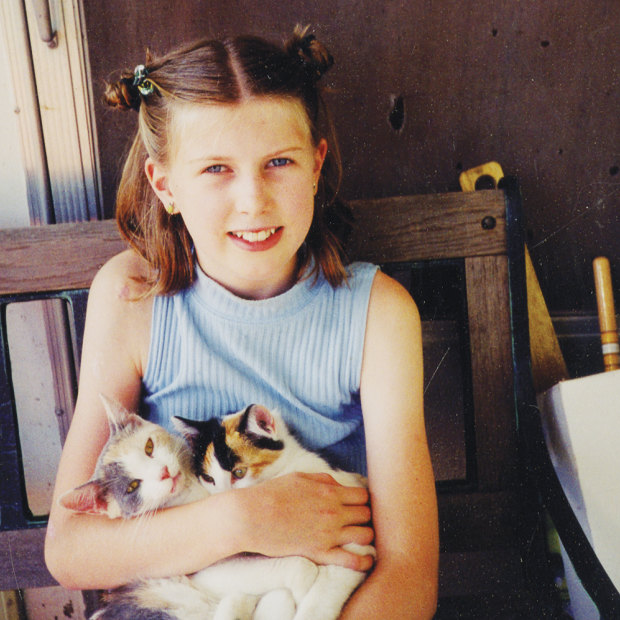 Anna, aged 11, with some kittens on a visit to the Iowa farm where her mother grew up.