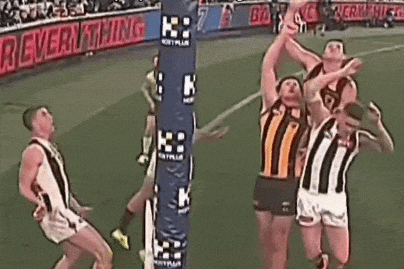Collingwood’s Sam Swadling punches the post-siren kick from Dylan Moore into the field of play, ensuring Saturday night’s match at the MCG ended in a draw.