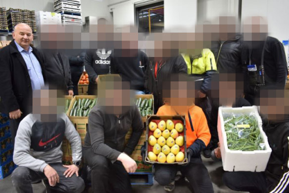 John Latorre with co-workers at his wholesale fruit and vegetable shop at the Melbourne Market in Epping.