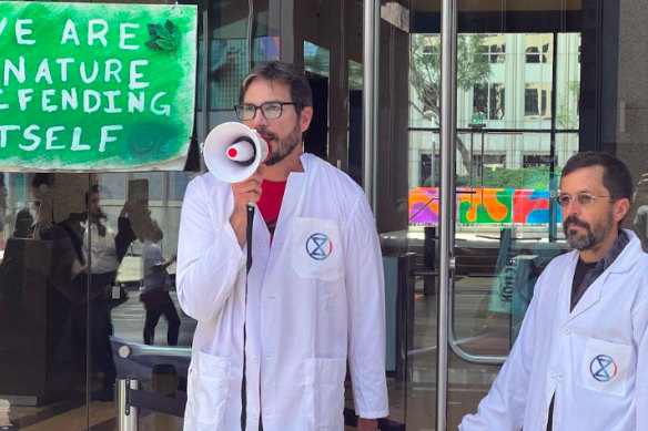 Peter Kalmus (centre), a NASA scientist, says frustration drove him to break the law.