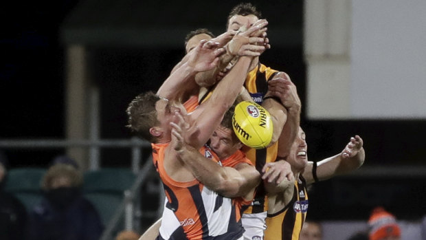 A throng of players contest the mark during the Hawks win over GWS.