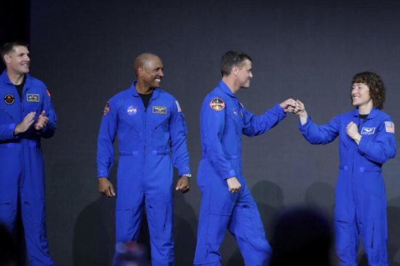 From left, Jeremy Hansen, Victor Glover, Reid Wiseman and Christina Hammock Koch, celebrate on stage as they are announced as the Artemis II crew in Houston.