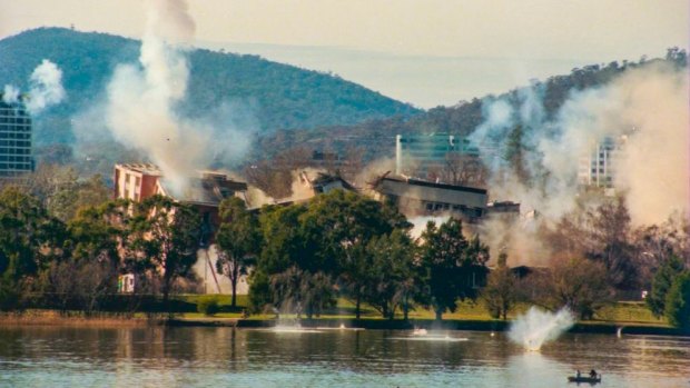 The implosion of the Royal Canberra Hospital as captured by a Canberra Times' photographer, showing debris hitting the water.
