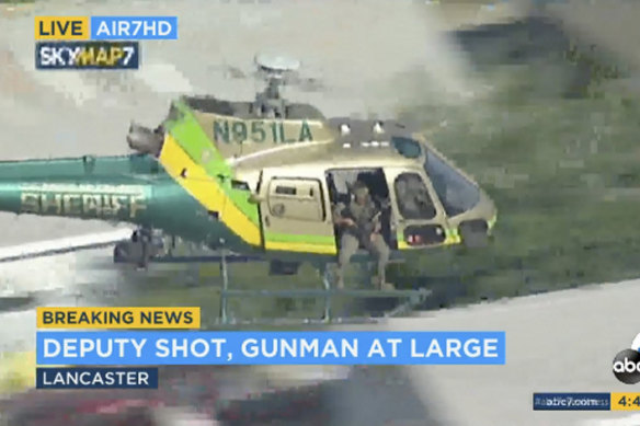 A sheriff's department helicopter with a sniper in an open door search for what they thought was a gunman at large in Lancaster, California. 