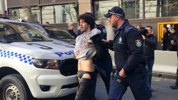 Mert Ney is arrested after being detained by members of public. 