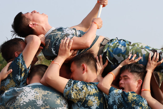 HQD’s employees, pictured here, are put through “Wolf Warrior” training drills. 