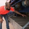 Truck driver Pardeep Dahiya shows where a man stowed away under his truck from Nambucca Heads in NSW to the Gold Coast on November 20, 2023.
