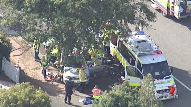 The crash scene in Murrumba Downs after a car lost control on a roundabout and hit a tree.