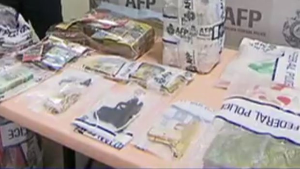 Drugs, money and the golden gun seized by police during the raid. 