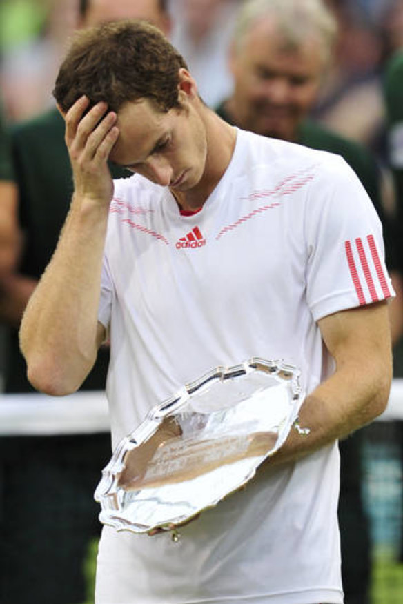Britain's Andy Murray stands with his runners-up trophy after his 2012 Wimbledon men's singles final defeat to Federer. 