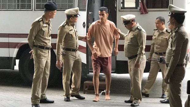 Hakeem Al-Araibi arrives at the Bangkok court on Monday with his legs shackled.