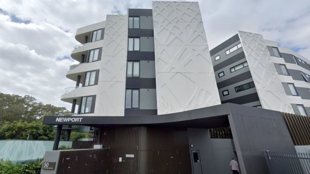 The woman’s body was found at the Newport Hamilton Apartments in Brisbane on Monday.