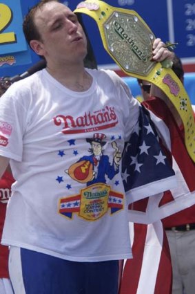 Champion:  Joey Chestnut with the Mustard Belt.