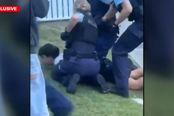 Police making an arrest at the Kirrawee party.