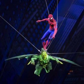 Spider-Man rides on the Green Goblin during a fight sequence during the musical.
