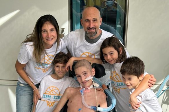 Ezra in hospital surrounded by his family (from left) mum Natasha, brother Alon, dad Dean and brothers Levi and Eden.