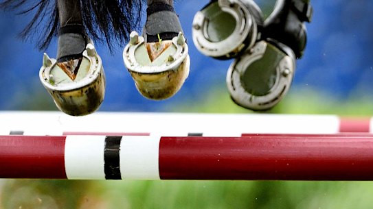 The hooves of a horse are seen as a show jumper overcomes an obstacle during the CHIO equestrian event in Aachen, western Germany.