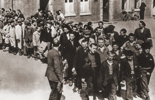 Newsreel footage of boys being escorted out of Buchenwald concentration camp after liberation by the US Army.