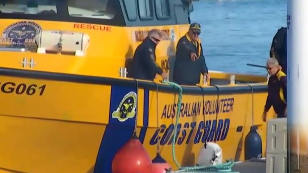 A boy is in a critical condition after being winched from the water on the Sunshine Coast after he was on a boat with two men before it sunk.