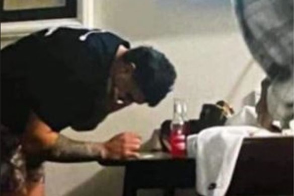 Latrell Mitchell appearing to lean over a table with a white substance on it. There is no suggestion the substance is an illicit drug.