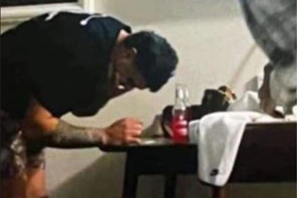 Latrell Mitchell appearing to lean over a table with a white substance on it. There is no suggestion the substance is an illicit drug.