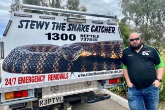 Colourful reptile wrangler Stewart ‘Stewy the Snake Catcher’ Gatt standing next to his truck.