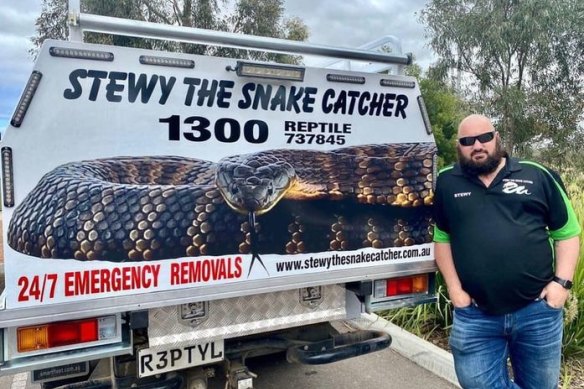 Colourful reptile wrangler Stewart “Stewy the Snake Catcher” Gatt standing next to his truck.
