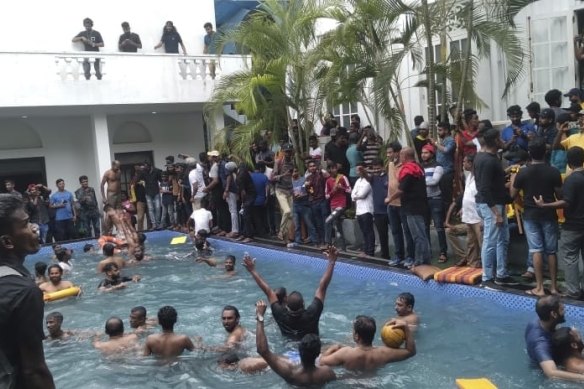 Protesters take a dip in the president’s pool. 