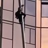 Man free climbs a building in Melbourne.