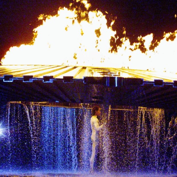 The cauldron rises above Cathy Freeman on September 15, 2000.