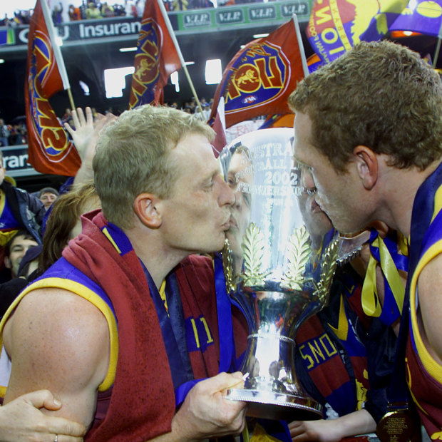 Michael Voss and Justin Leppitsch celebrate winning the 2002 AFL premiership.