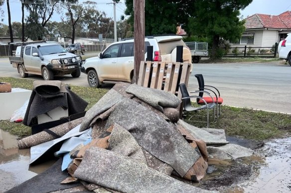 Destroyed carpet and furniture outside the flooded St Joseph’s Catholic Primary School in Rochester.