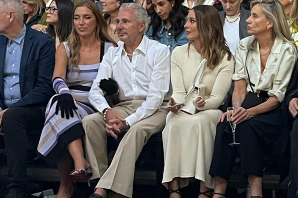 Former Telstra chief executive Andy Penn gets into the spirit of things with wife Kallie Blauhorn at Melbourne Fashion Week.