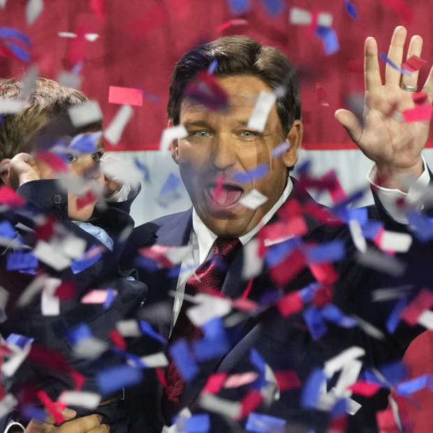 Ron DeSantis holds his son Mason as he celebrates winning reelection.