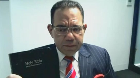 Former Casey mayor Sam Aziz swears his oath at anti-corruption commission hearings on Monday.