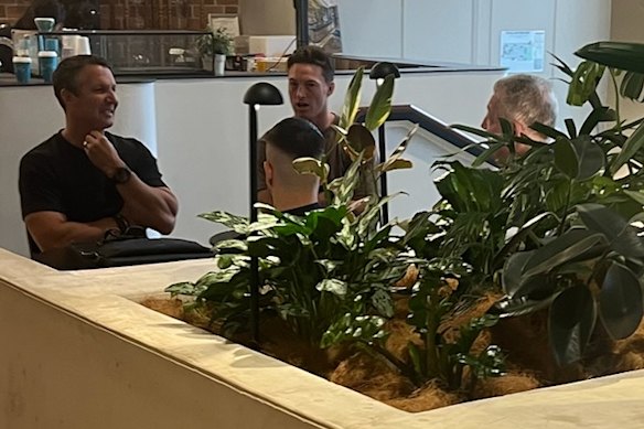 Titans hooker Sam Verrills (centre) and his management team meet Bulldogs general manager Phil Gould (right).