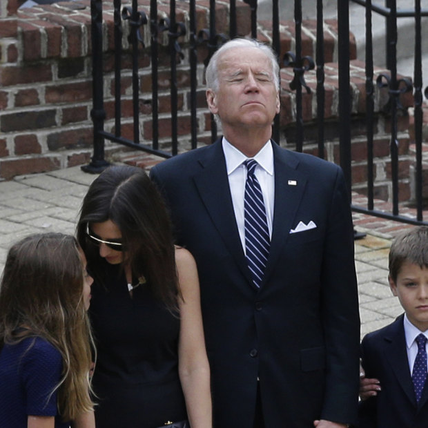 Joe Biden, centre, pauses alongside his family as they to enter a visitation for his son, former Delaware attorney-general Beau Biden, after he died of brain cancer aged 46 in 2015.