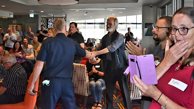 Deputy Commissioner Rick Nugent congratulates Ron Fenton at his “living wake”.