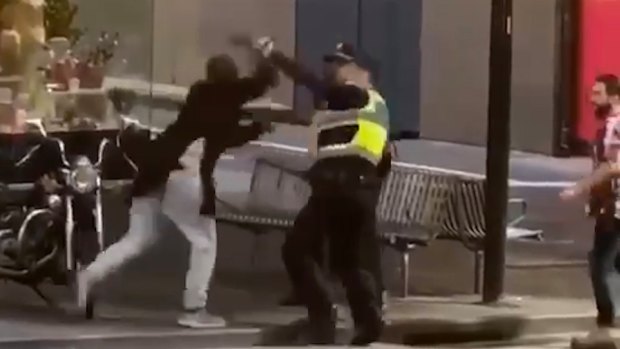 Police confronting Bourke Street attacker Hassan Khalif Shire Ali last Friday.