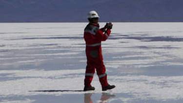Rich in lithium: A worker walks on salt at a semi-industrial plant to produce potassium chloride, used to manufacture batteries based on lithium, at the Uyuni salt desert, outskirts of Llipi, Bolivia.