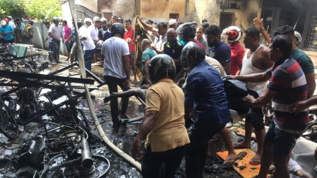 Witnesses go through the wreckage of the Zion Church in Batticaloa, Sri Lanka.