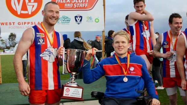 Beau Vernon with Phillip Island's 2018 premiership cup.