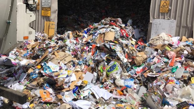 Waste that could have been recycled gushes out of an SKM facility in Melbourne's west.
