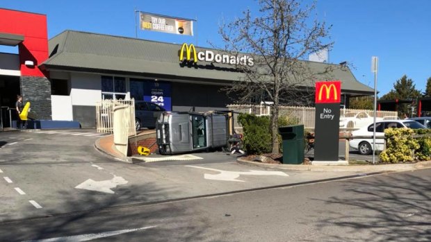 A car has rolled over at Belconnen McDonald's.
