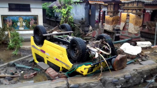 A ruined car that was rolled over after the tsunami hit Sunda Strait.