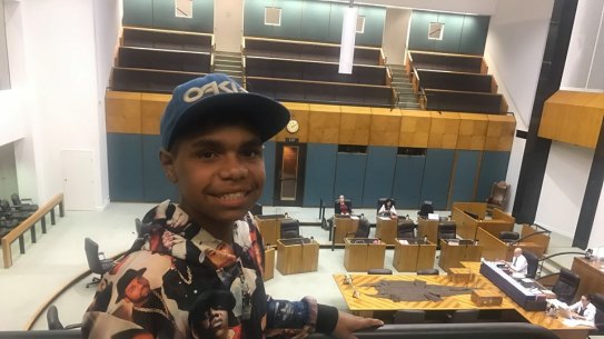 Dujuan Hoosen listens on as his speech is read in Northern Territory Parliament.
